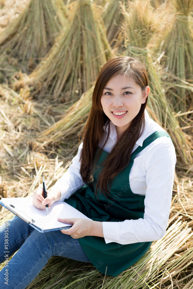 young asian woman in golden cereal field