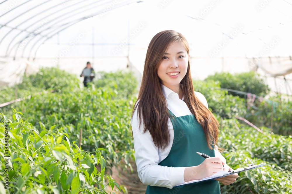 young asian woman working in green house