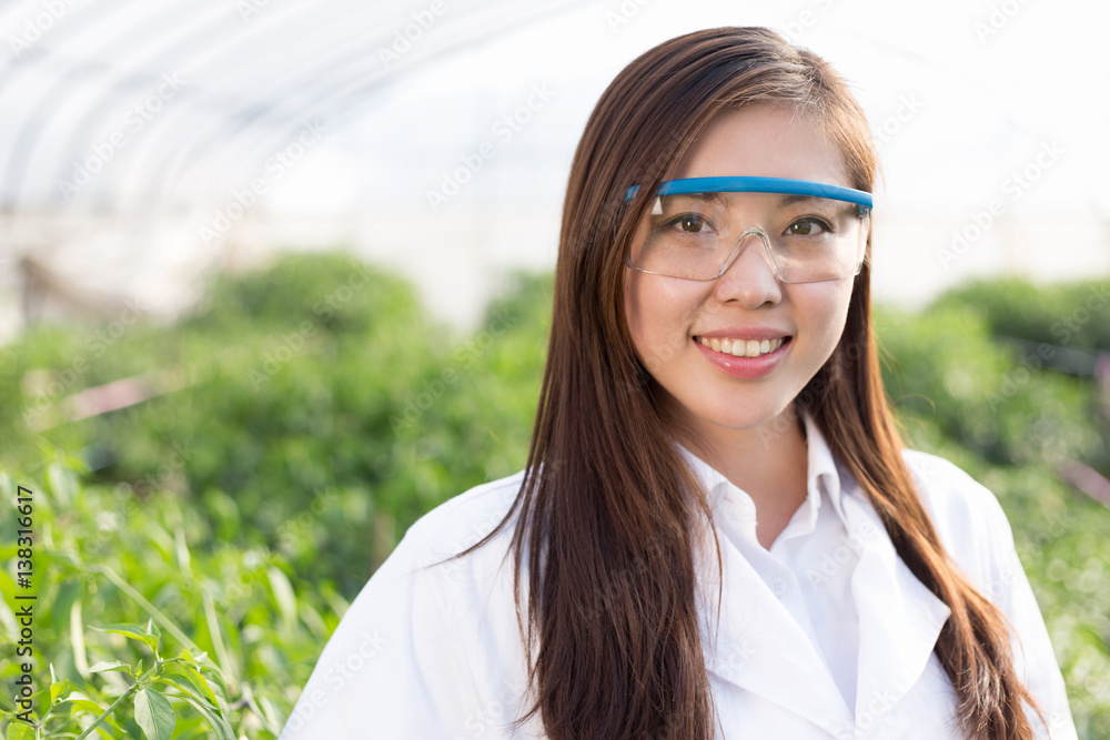 young asian woman working in green house