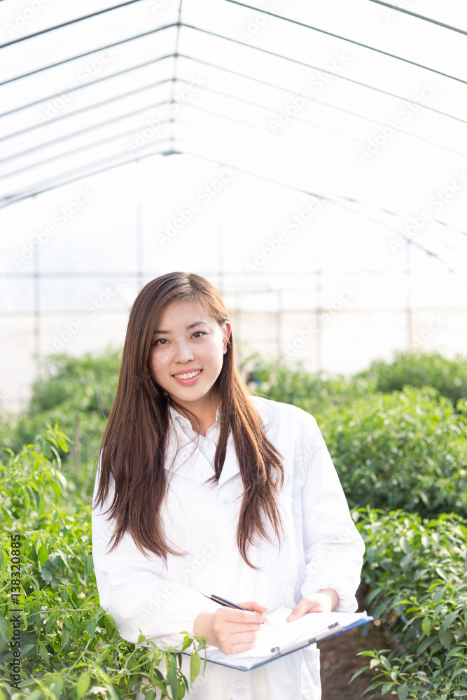 young asian woman working in green house