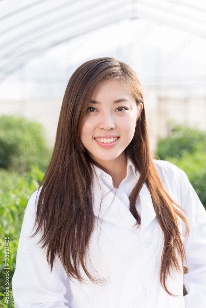 young asian woman working in green house