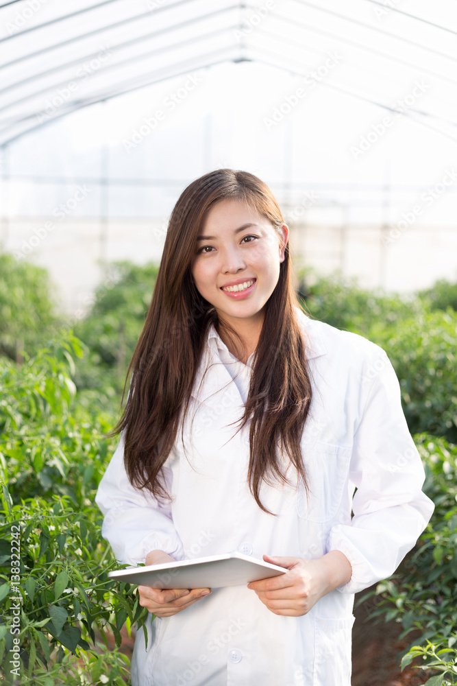 young asian woman working in green house