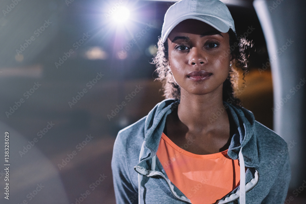 Young woman resting after night fitness in the city