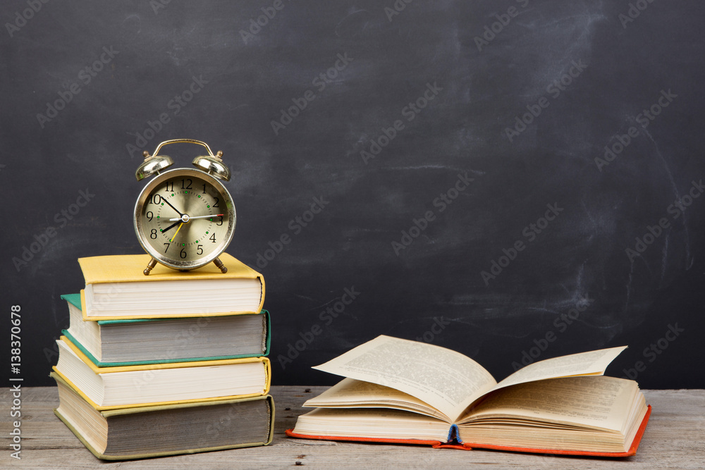 Education concept - books on the desk in the auditorium