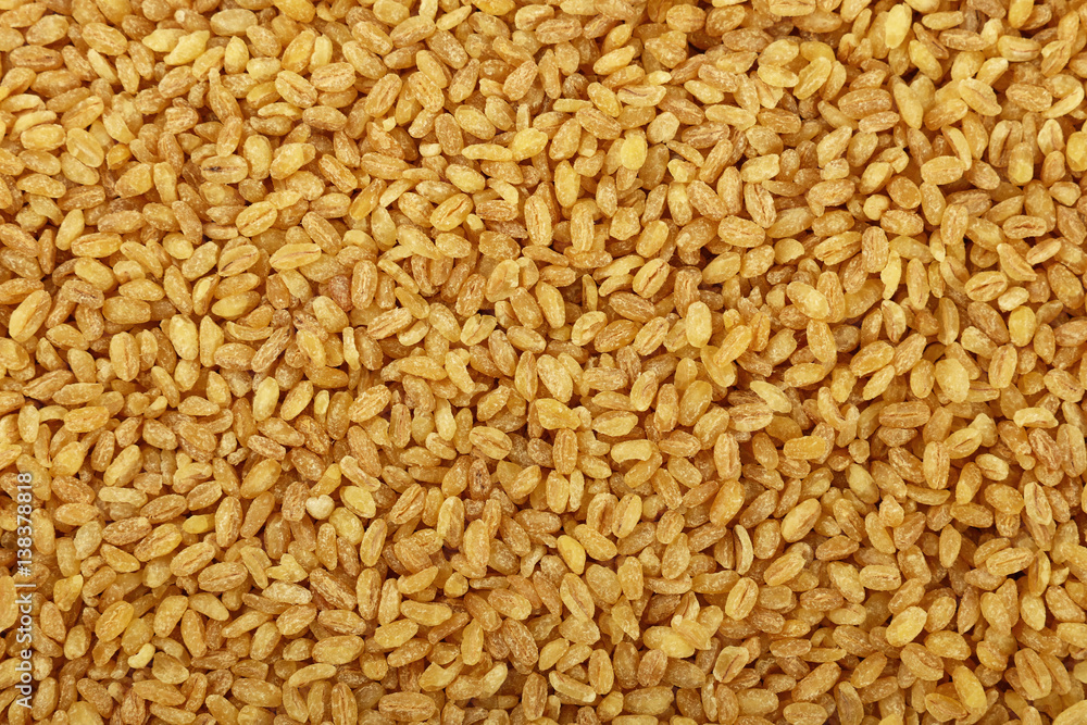 Yellow bulgur big grains close up background