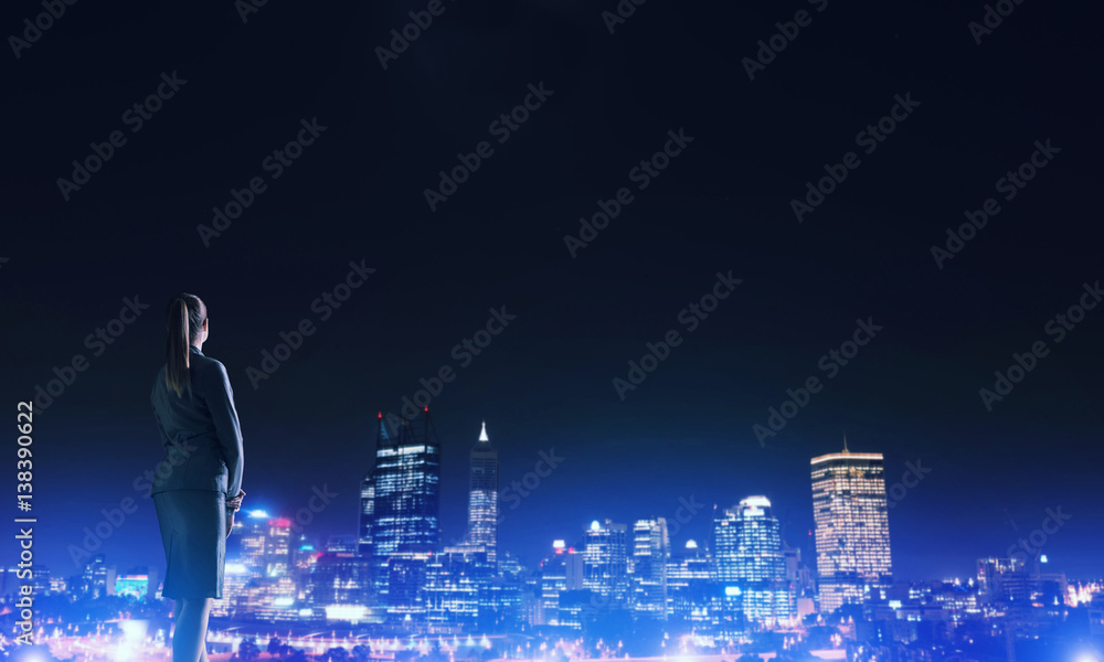 Woman looking at night city