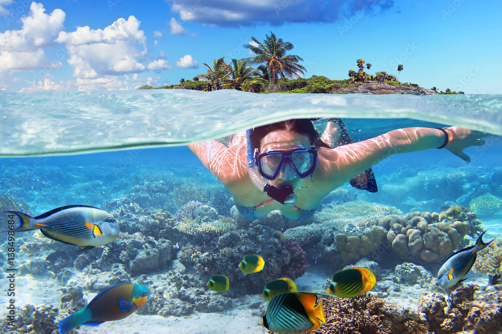 Young woman at snorkeling in the tropical water