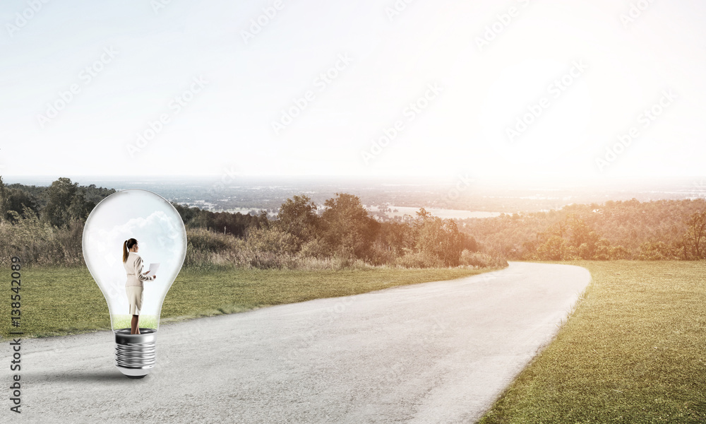 Businesswoman inside light bulb