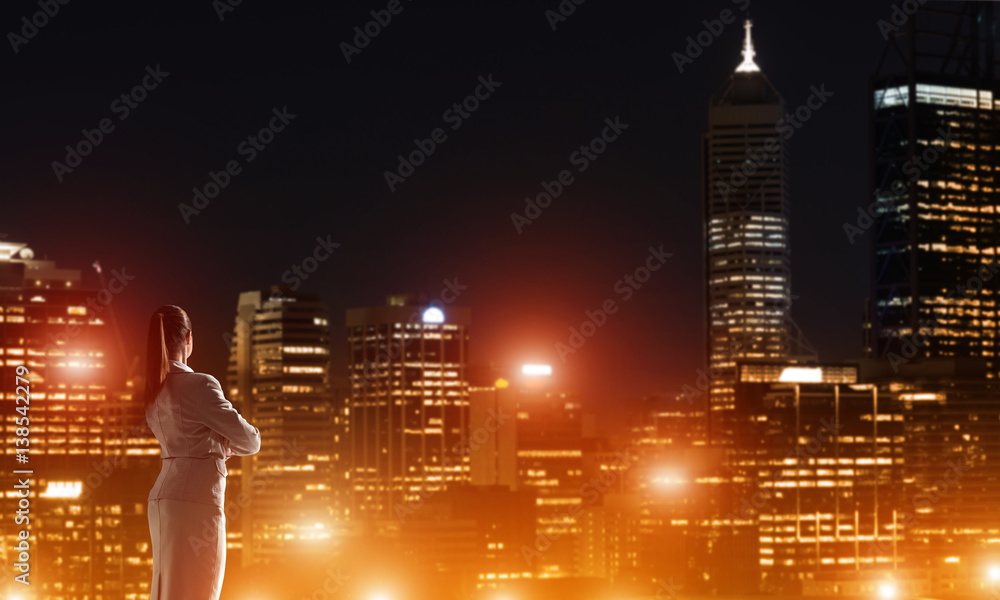 Woman looking at night city