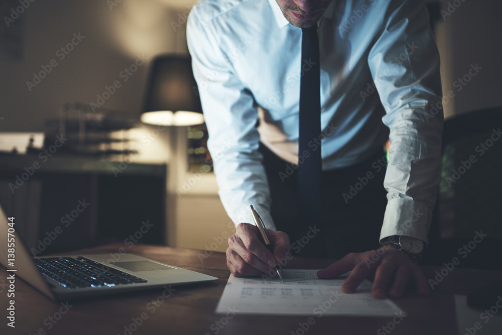 business man doing late night paperwork 