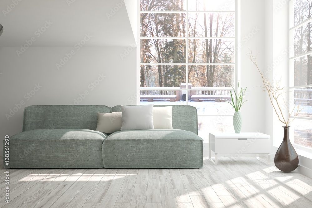 White room with sofa and winter landscape in window. Scandinavian interior design