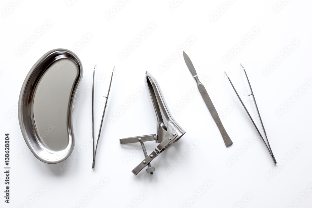 instruments of gynecologist on white background top view