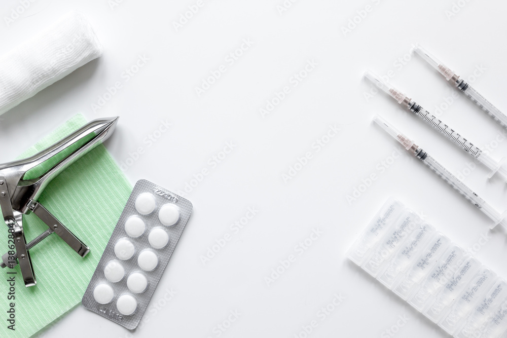 instruments of gynecologist on white background top view mock up