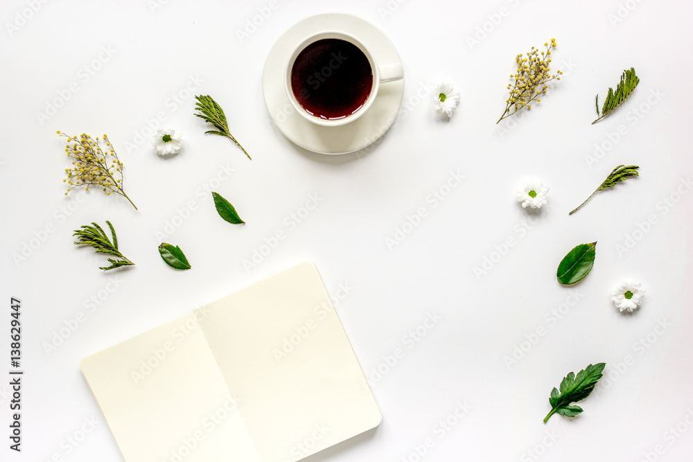 Copybook, americano and flowers on white table top view mock-up