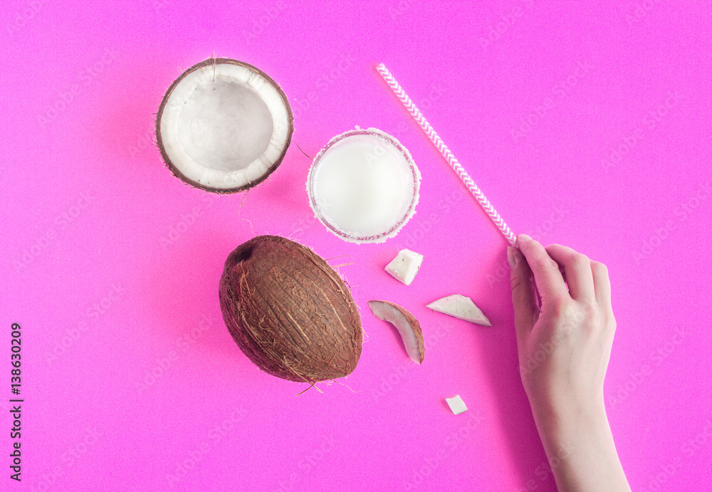 cocktail with coconut on purple background top view