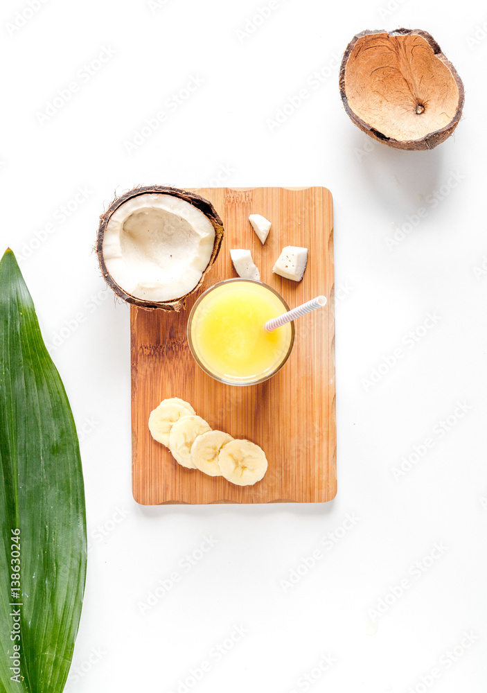 cocktail with coconut on white background top view