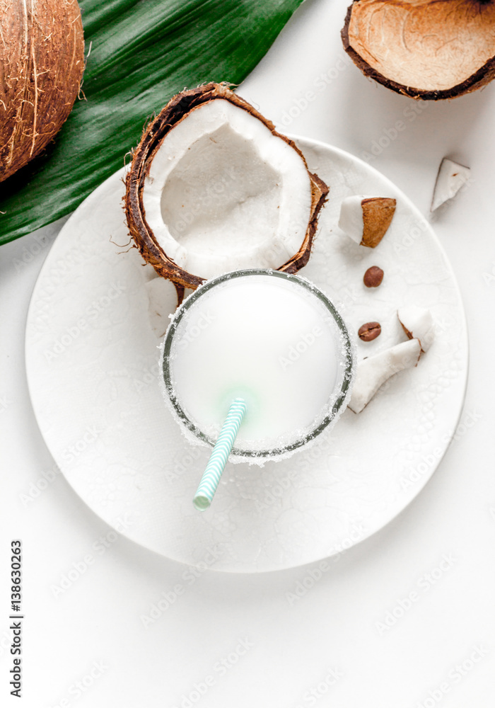 cocktail with coconut on white background top view