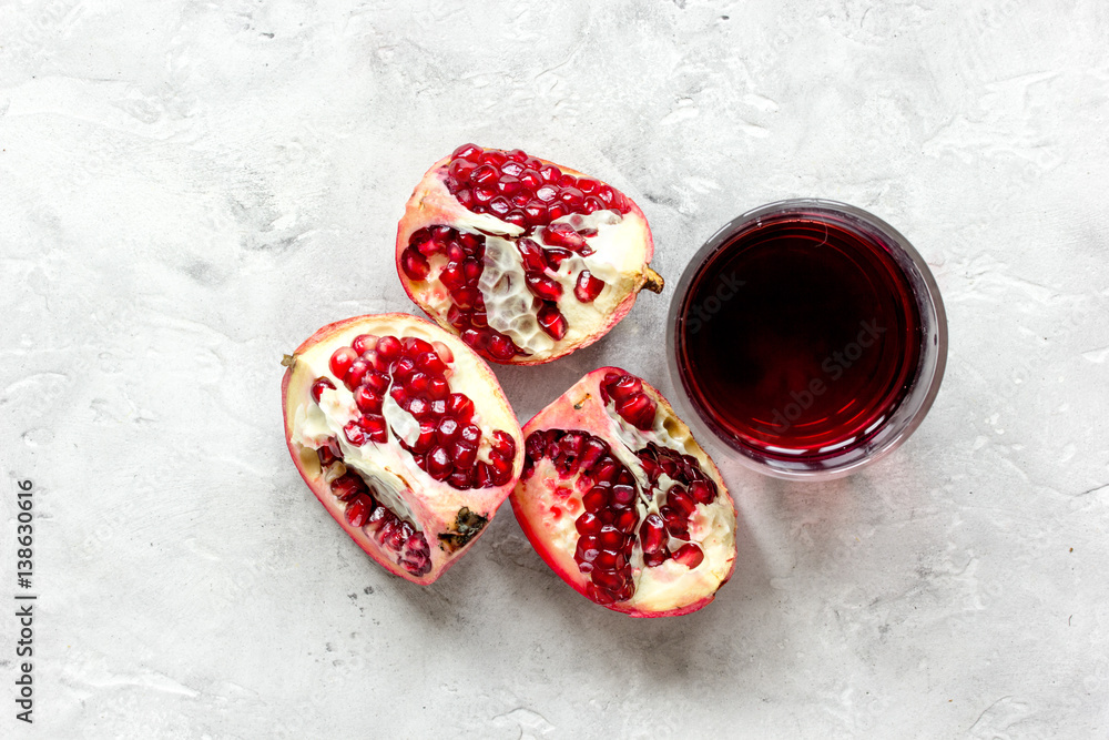 pomegranate juice with seed on stone table background top view mock up