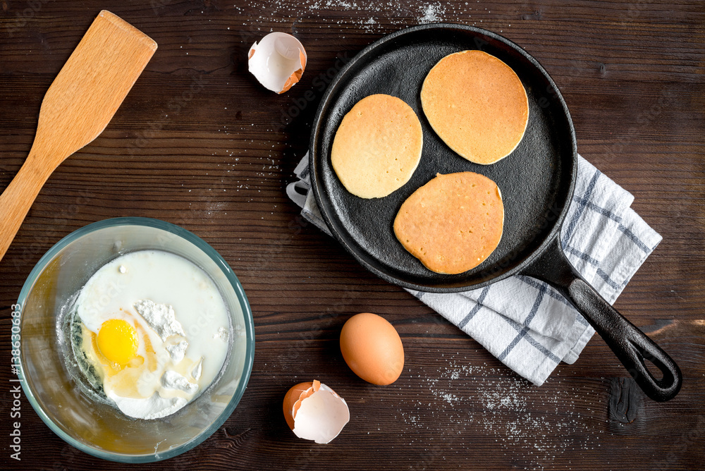 cooking pancake on wooden background top view ingredients for making