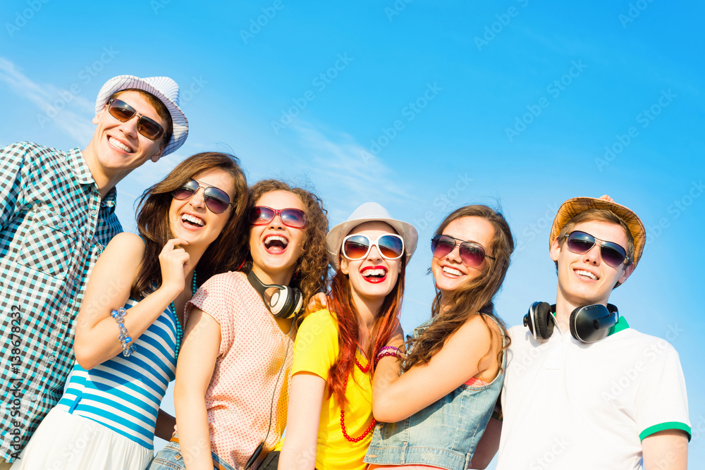 group of young people wearing sunglasses and hat