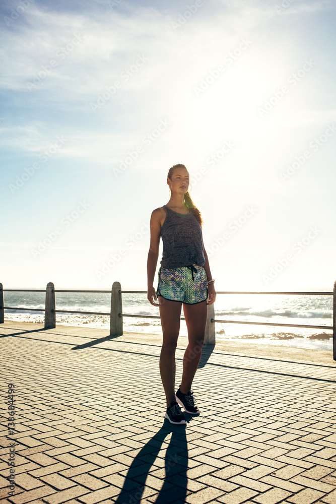 Young woman walking on the sea side promenade