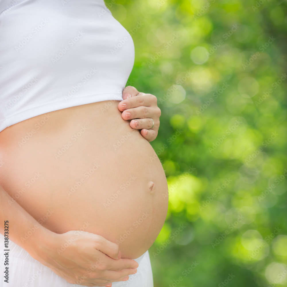 Beautiful belly of young pregnant woman