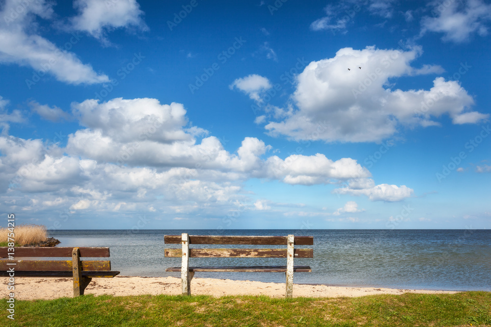 Bench on the sandy beach at the sea