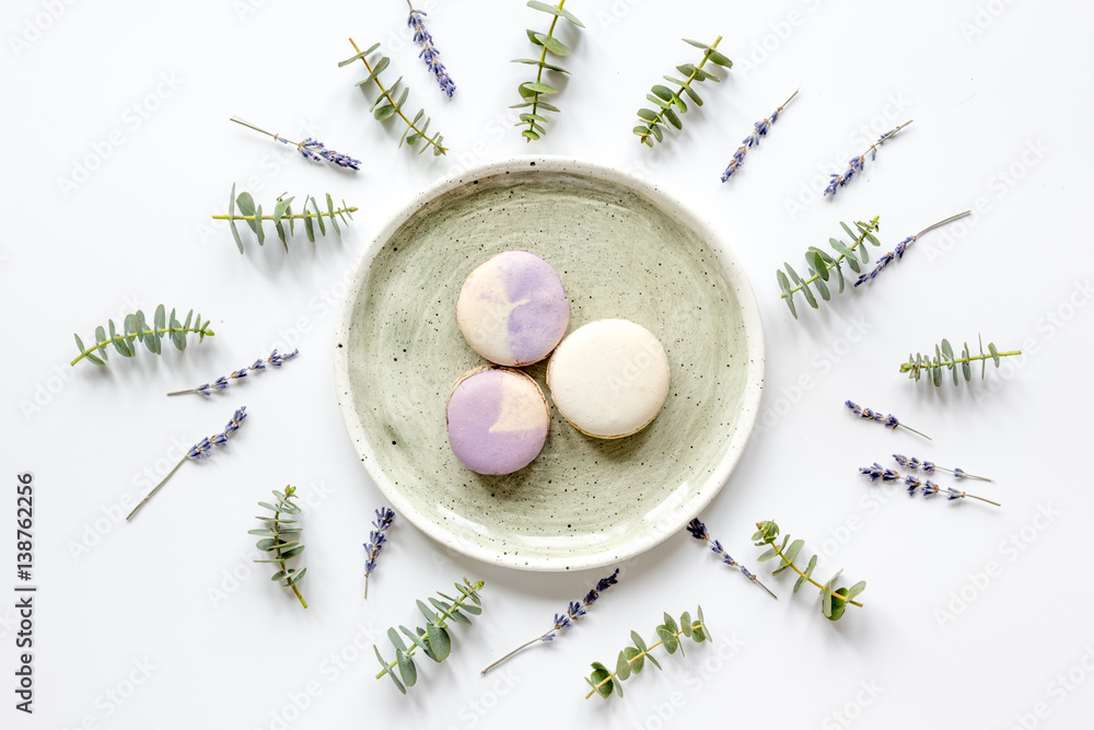 light breakfast with macaroons on spring pattern white background top view