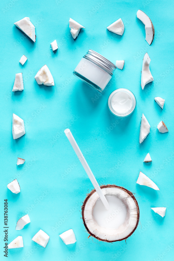 concept organic cosmetics with coconut on blue background top view