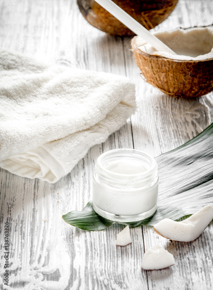 organic cosmetics with coconut on wooden background close up