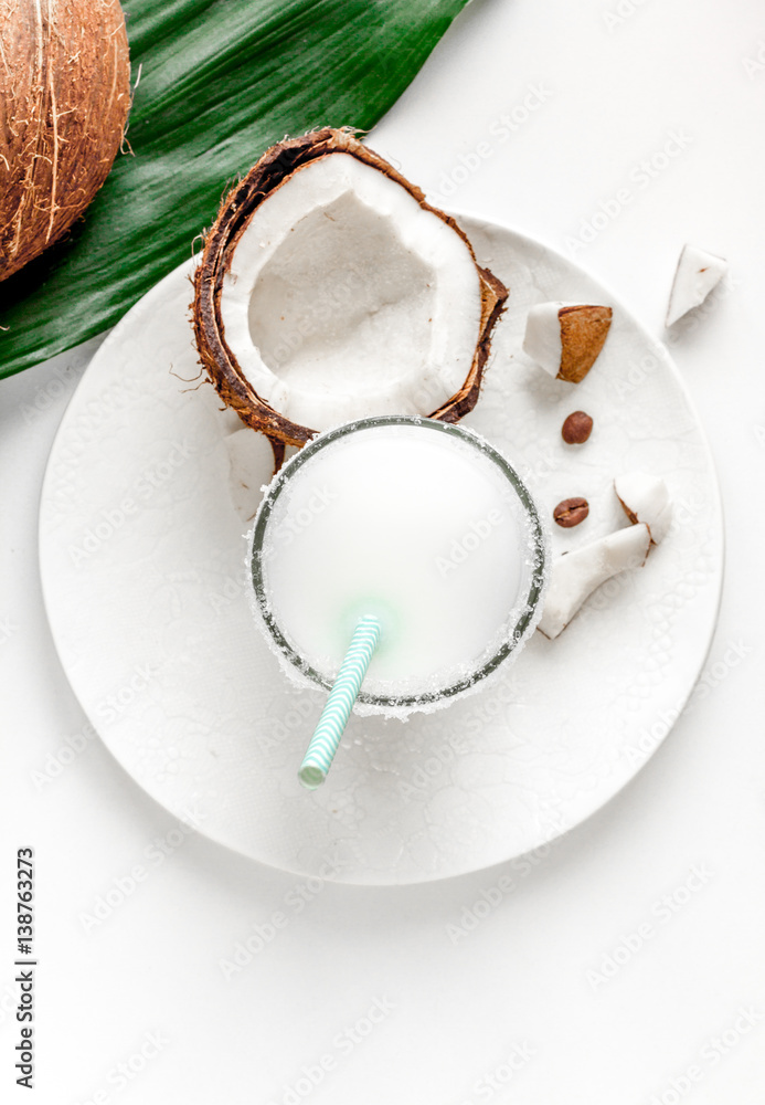 cocktail with coconut on white background top view