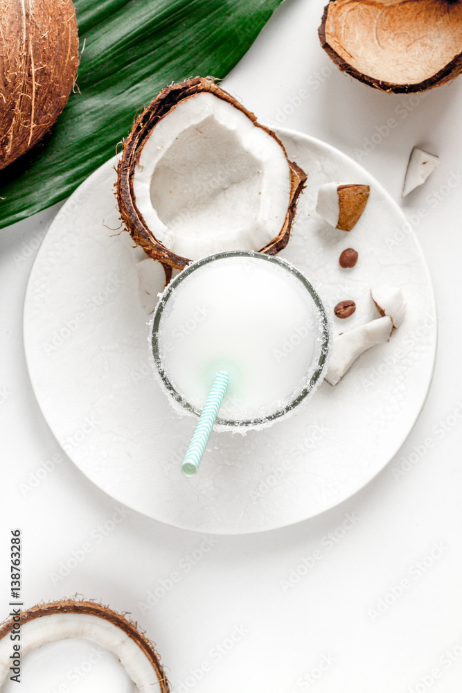 cocktail with coconut on white background top view