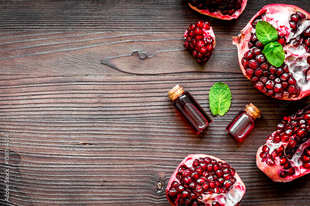 sliced pomegranate on wooden background top view