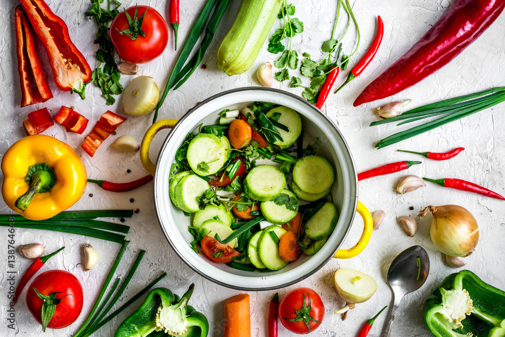 cooking vegetables on the stone background top view