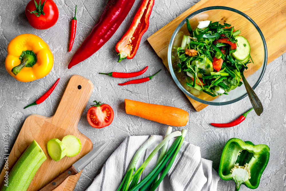 cooking vegetables on the stone background top view