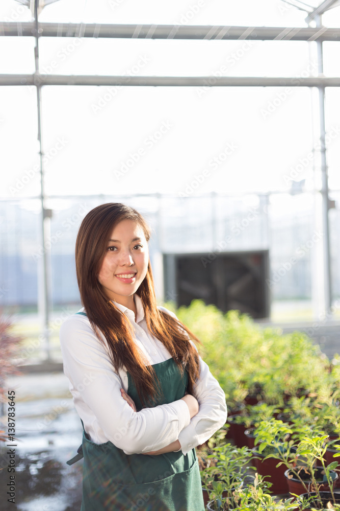 young beautiful asian woman works in green field