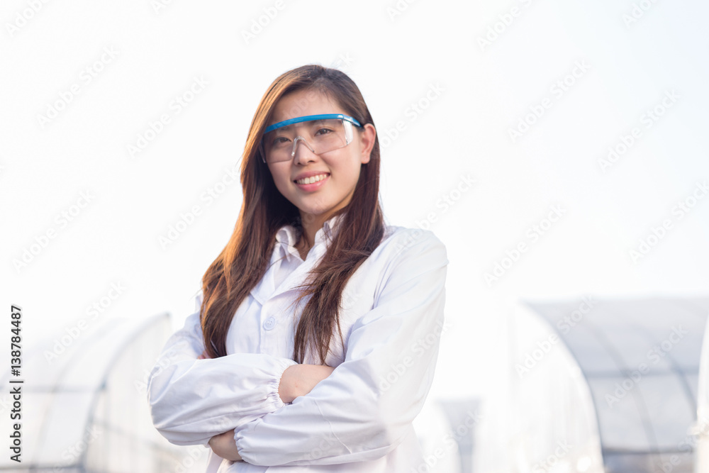 young beautiful asian woman works in green field