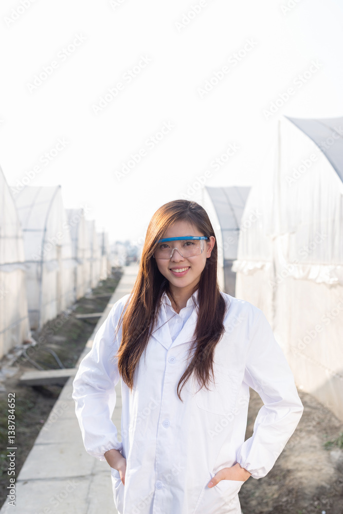 young beautiful asian woman works in green field