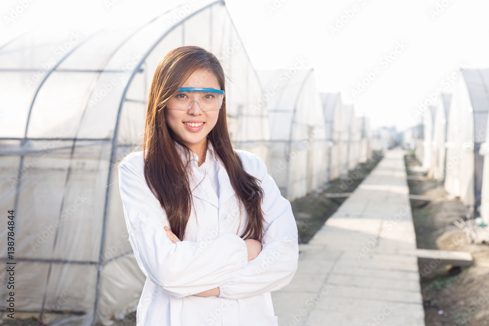 young beautiful asian woman works in green field