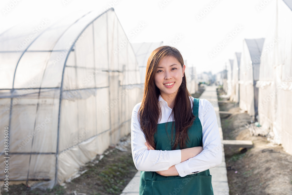 young beautiful asian woman works in green field