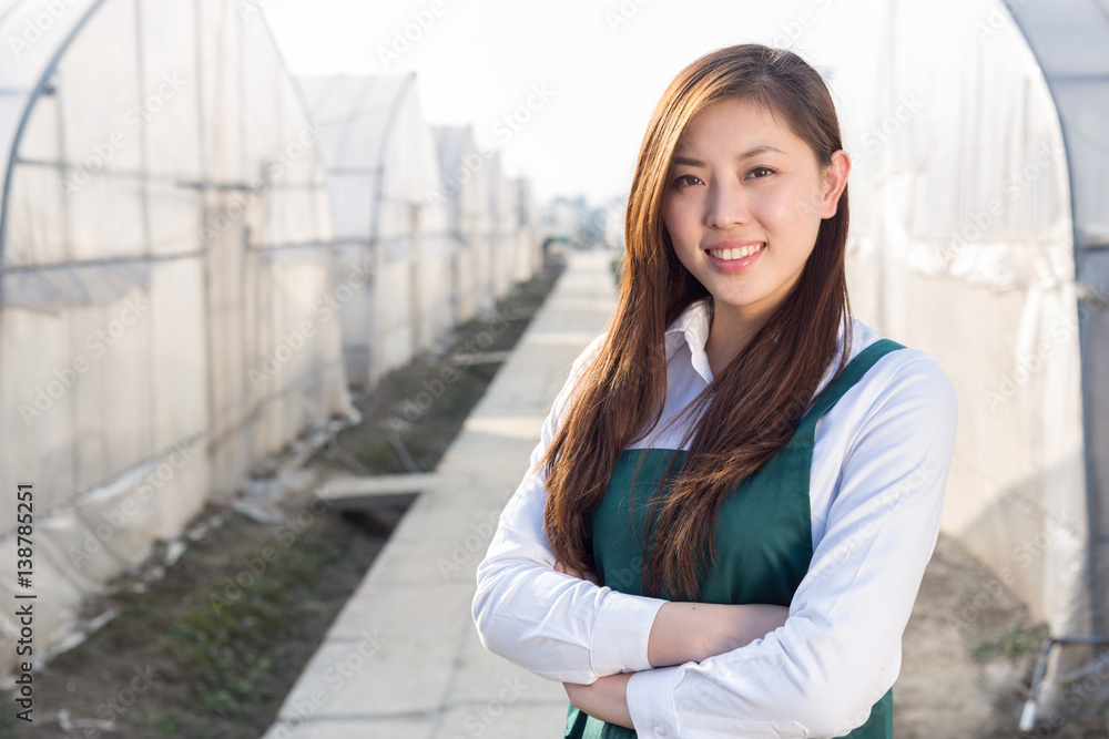 年轻漂亮的亚洲女人在绿茵场工作