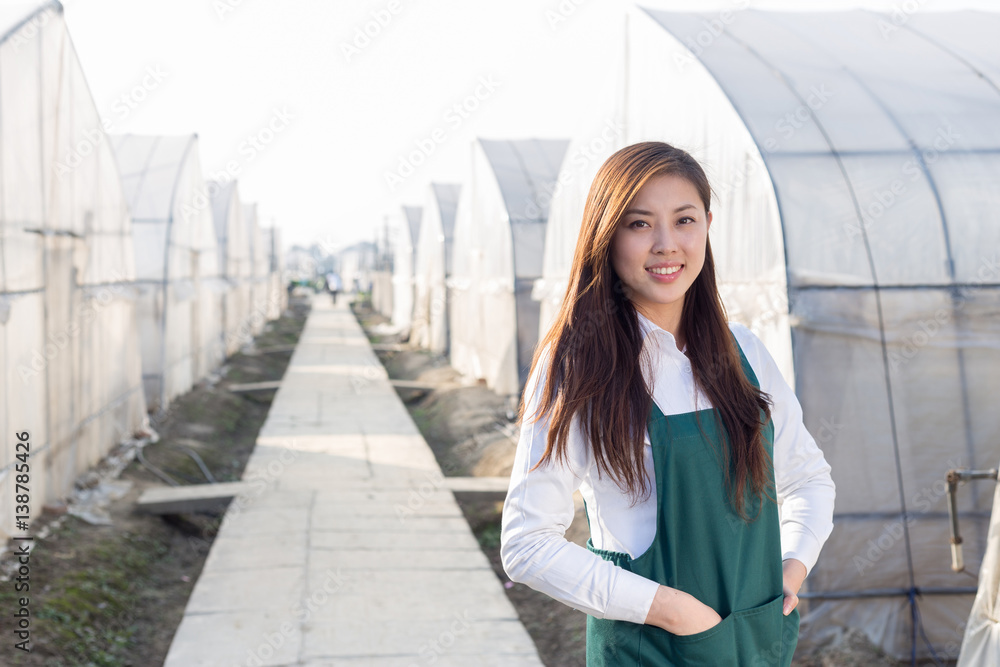 young beautiful asian woman works in green field