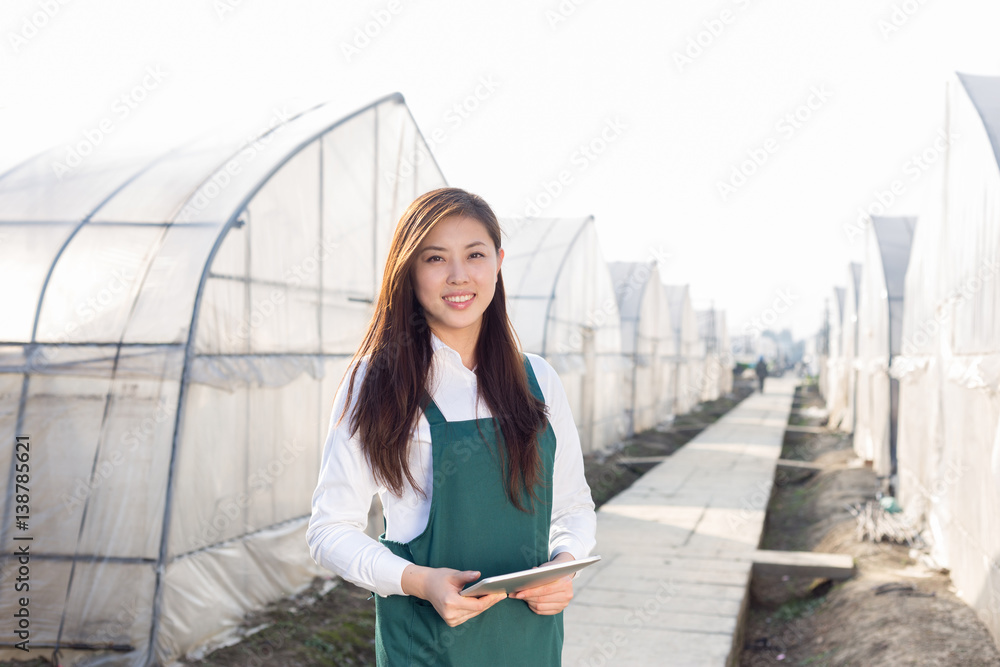 young beautiful asian woman works in green field