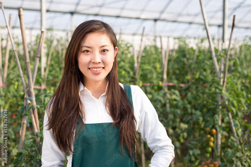 young beautiful asian woman works in green field