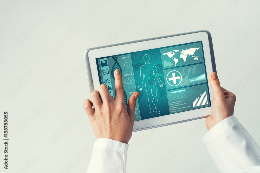 Close of female doctor hands working with tablet pc computer