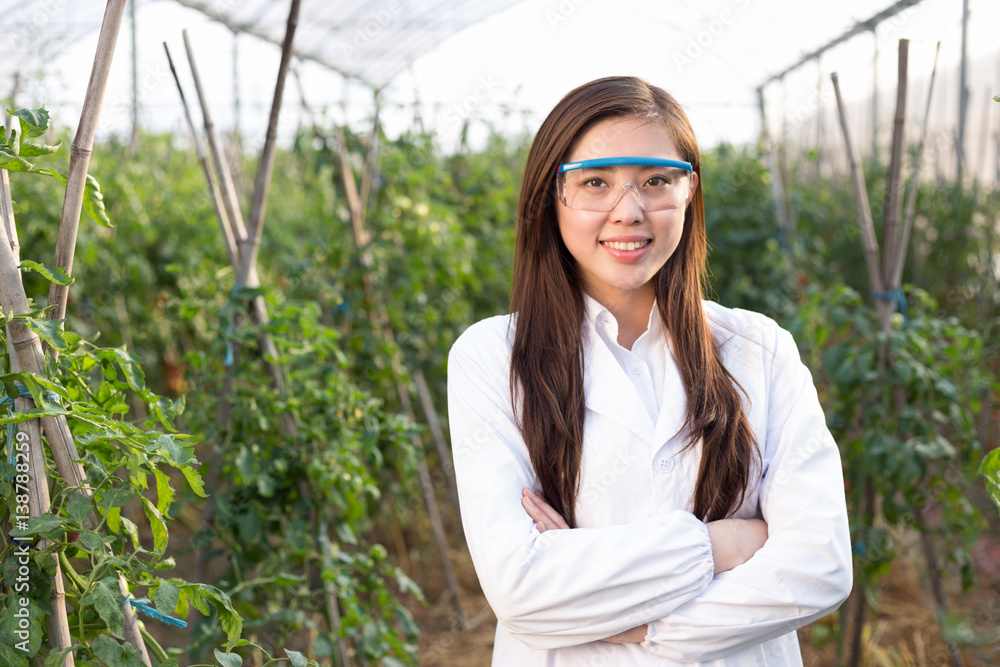 young beautiful asian woman works in green field