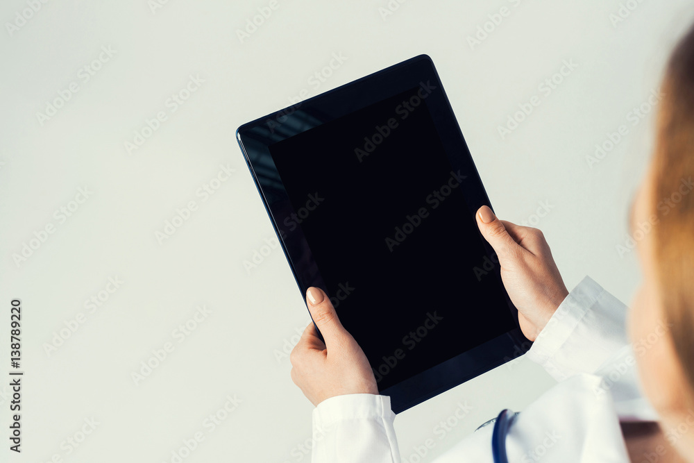 Close of female doctor hands working with tablet pc computer