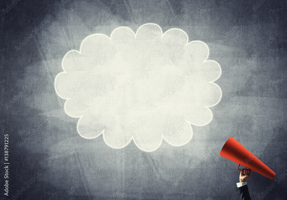 Hand of businesswoman holding red paper trumpet and speech cloud