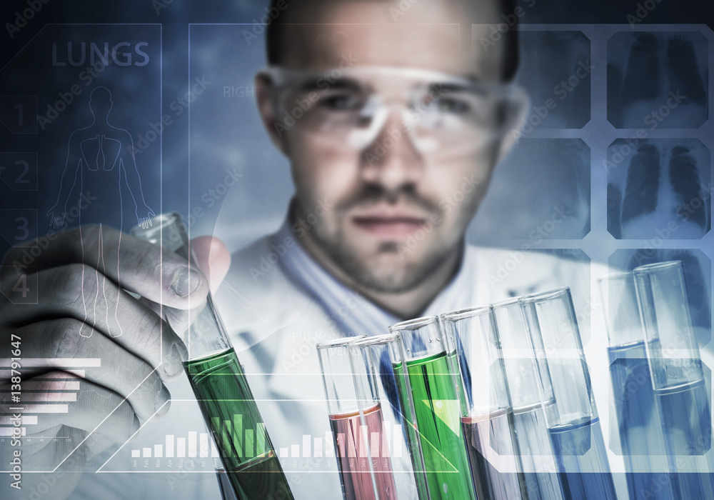 Portrait of concentrated male scientist working with reagents in laboratory