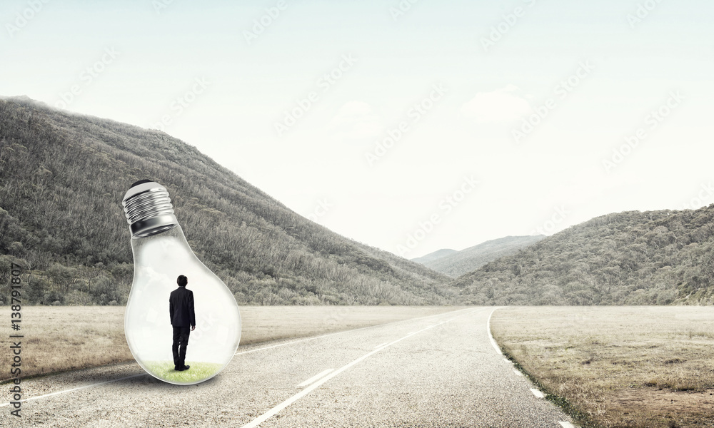 Businessman inside light bulb